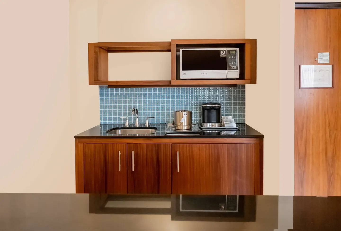 In-room kitchenette with sink, microwave, and coffee maker at Hilton Trinidad & Conference Centre.
