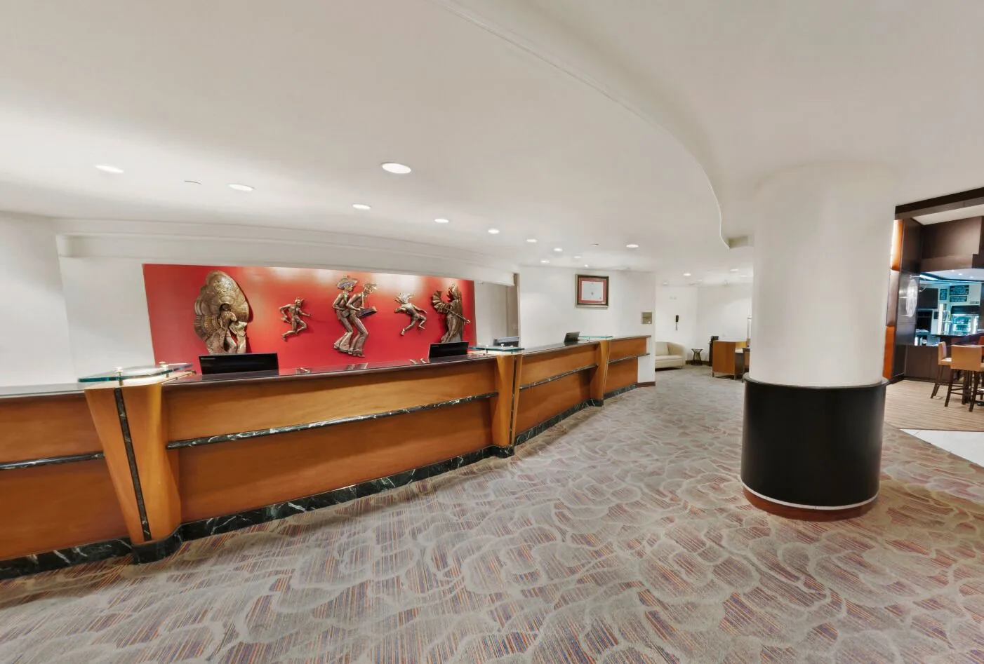 Reception desk with artwork in the lobby at Hilton Trinidad & Conference Centre.