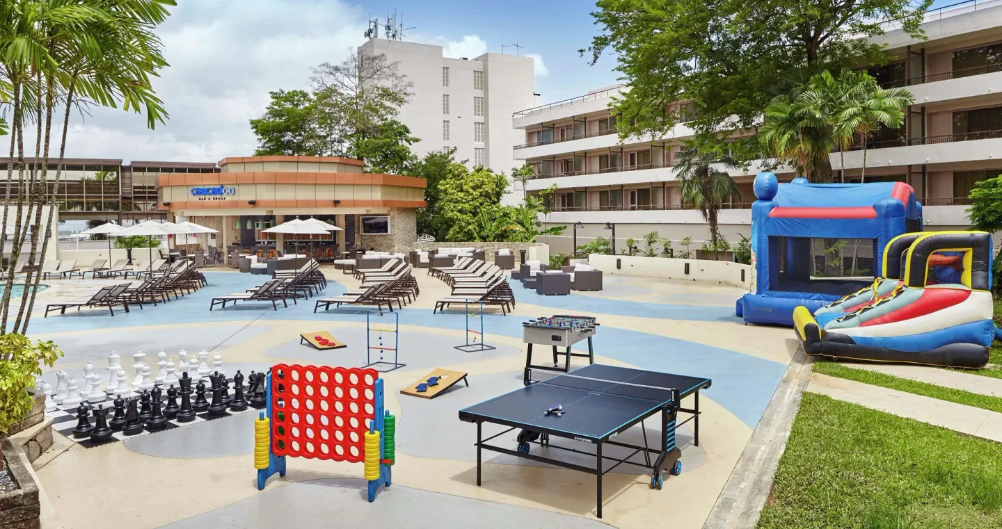 Outdoor games on the pool deck at Hilton Trinidad & Conference Centre.