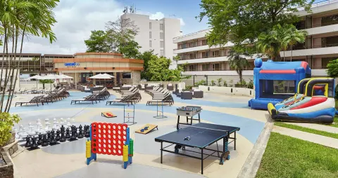 Outdoor games on the pool deck at Hilton Trinidad & Conference Centre.