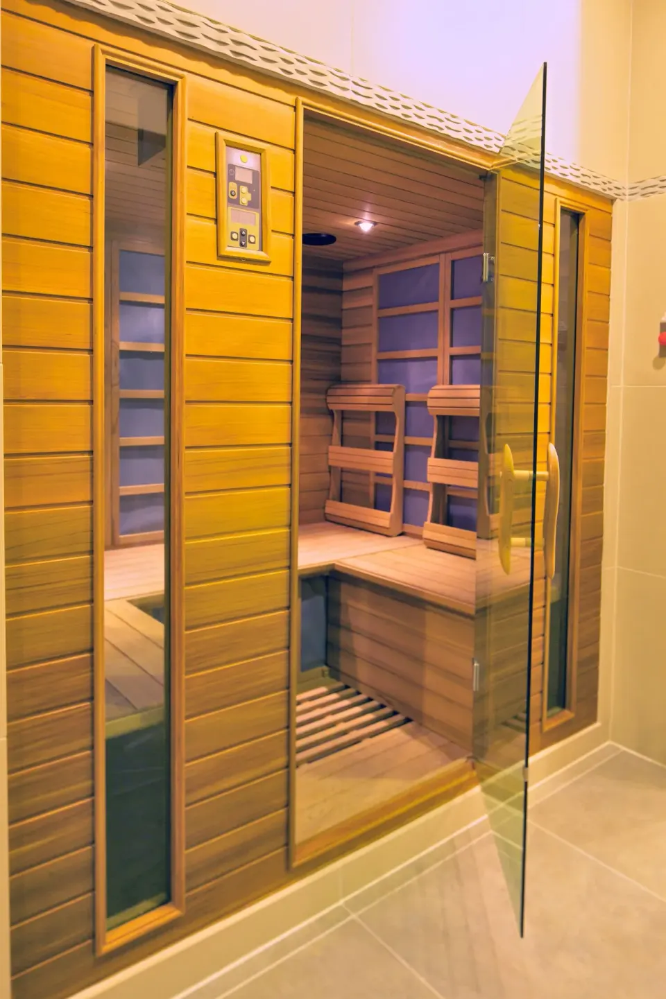 Wood-paneled sauna with glass door at Hilton Trinidad & Conference Centre.