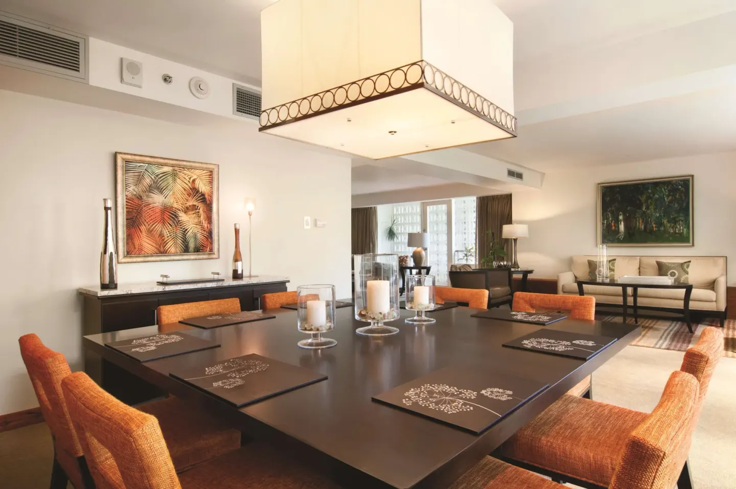 Dining table and lounge seating in a suite at Hilton Trinidad & Conference Centre.