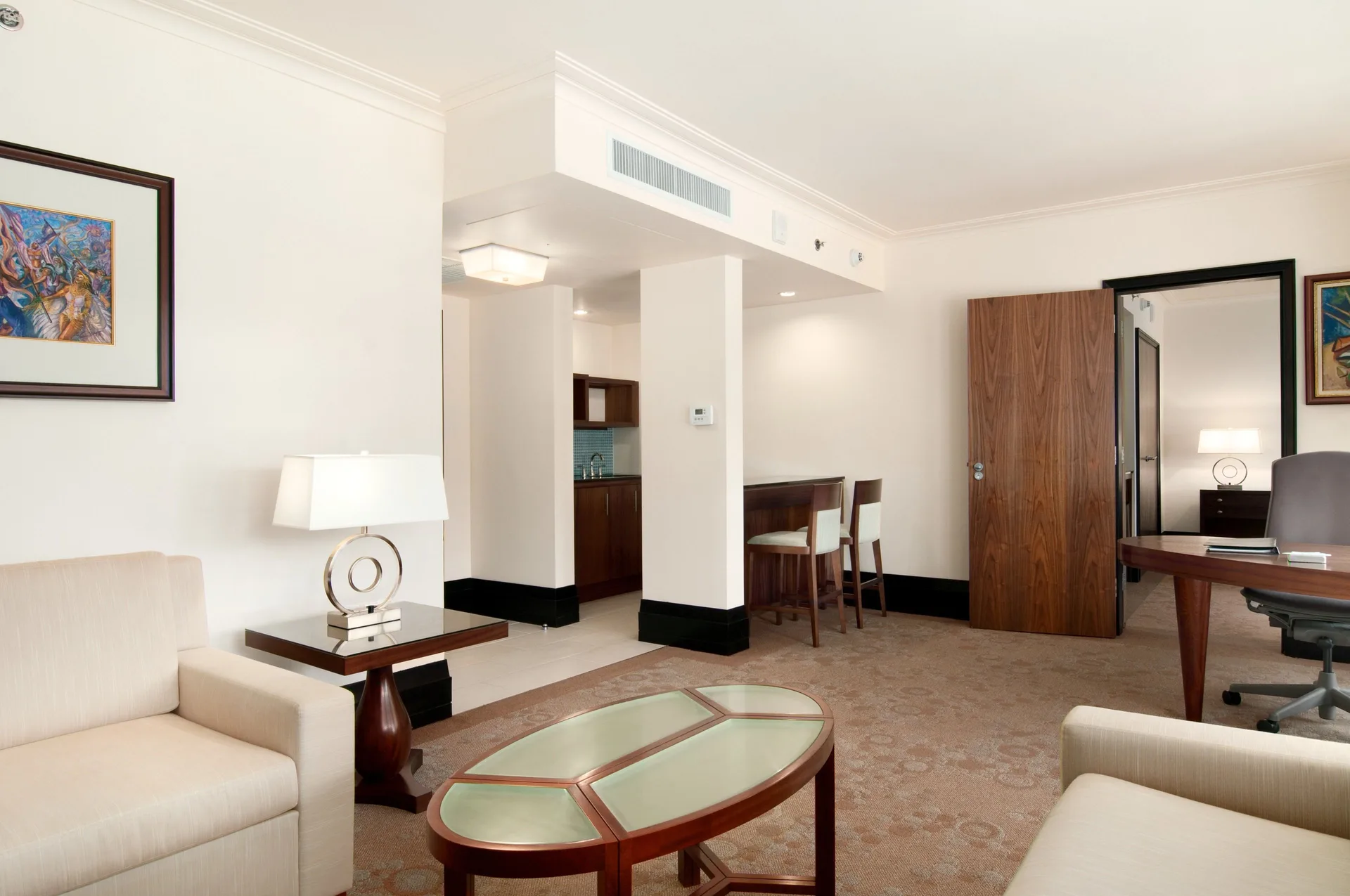 Deluxe Suite Sundeck living area at Hilton Trinidad and Conference Centre with modern furnishings and natural light.