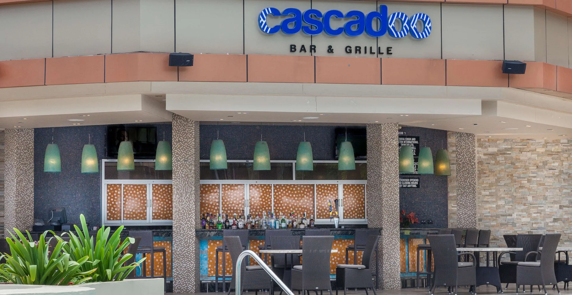 Cascadoo Bar & Grille entrance and bar seating at Hilton Trinidad & Conference Centre.