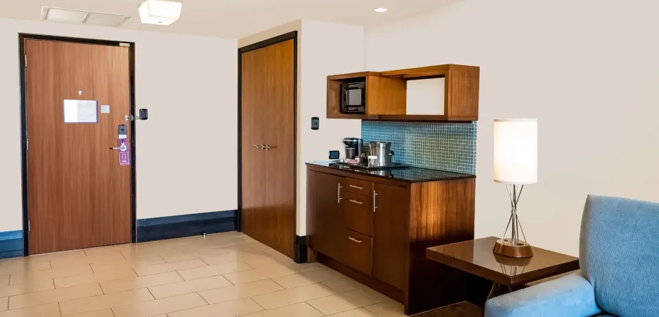 Deluxe Studio Suite kitchenette and entry area at Hilton Trinidad & Conference Centre.