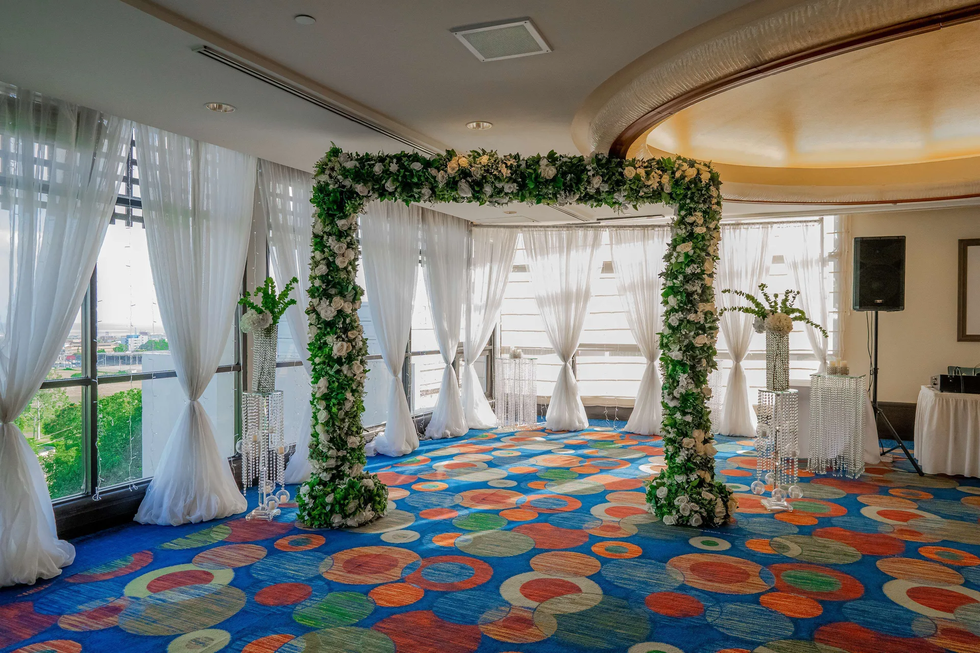 Floral wedding arch in an event room at Hilton Trinidad & Conference Centre.