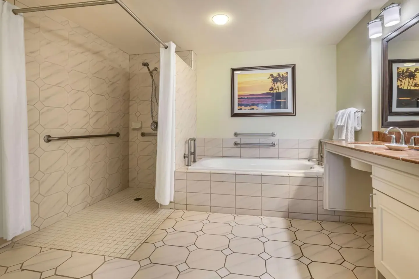 Accessible guest bathroom with roll-in shower and tub at Hilton Vacation Club The Point At Poipu Kauai.