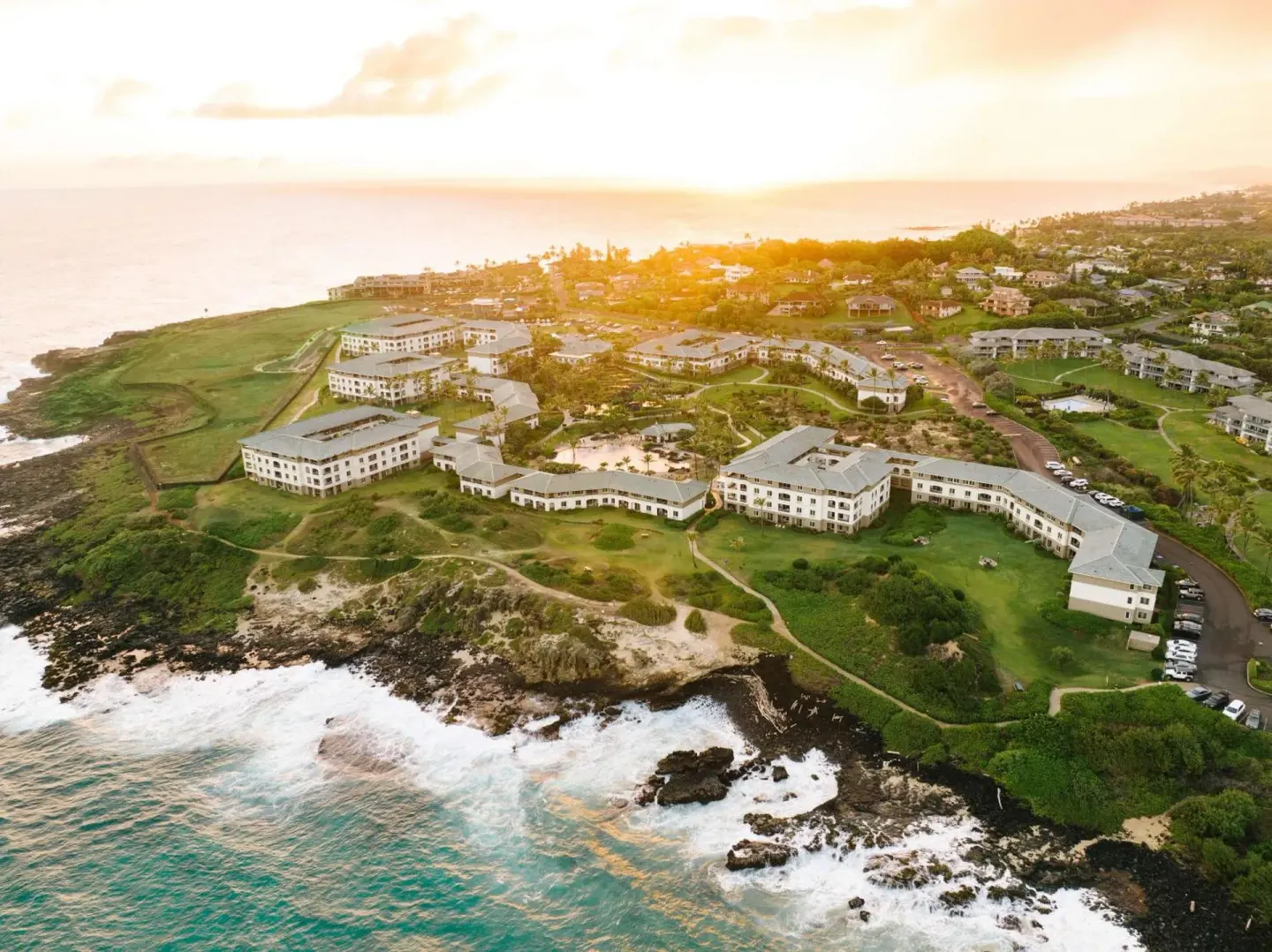 Aerial coastline view of Hilton Vacation Club The Point At Poipu Kauai at sunset.