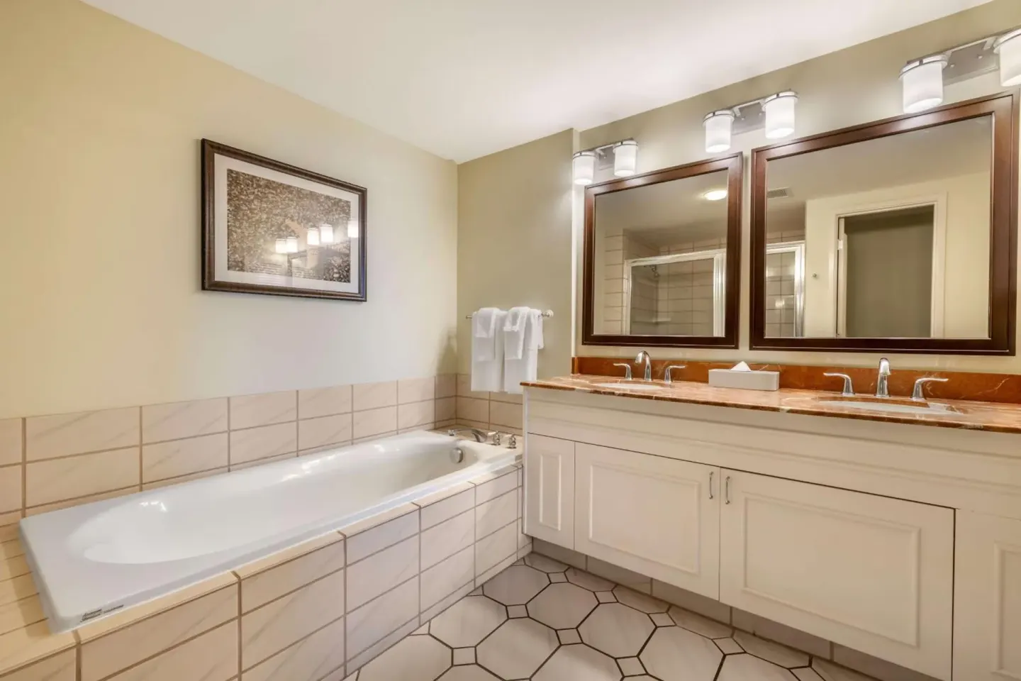 Guest bathroom with soaking tub and double vanity at Hilton Vacation Club The Point At Poipu Kauai.