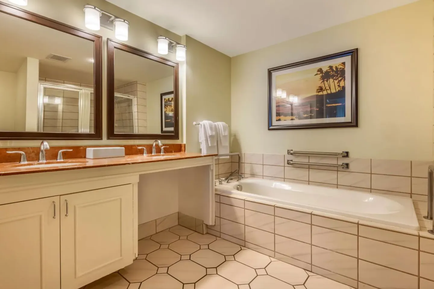 Bathroom with dual mirrors and soaking tub at Hilton Vacation Club The Point At Poipu Kauai.