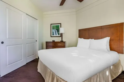 King bedroom with closet and dresser at Hilton Vacation Club The Point At Poipu Kauai.