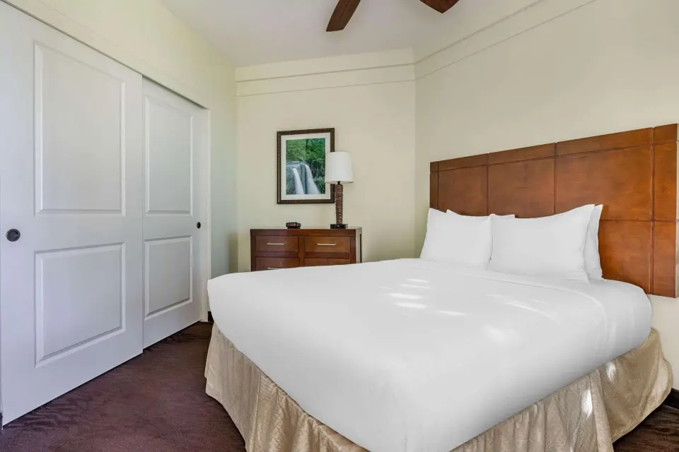 King bedroom with closet and dresser at Hilton Vacation Club The Point At Poipu Kauai.
