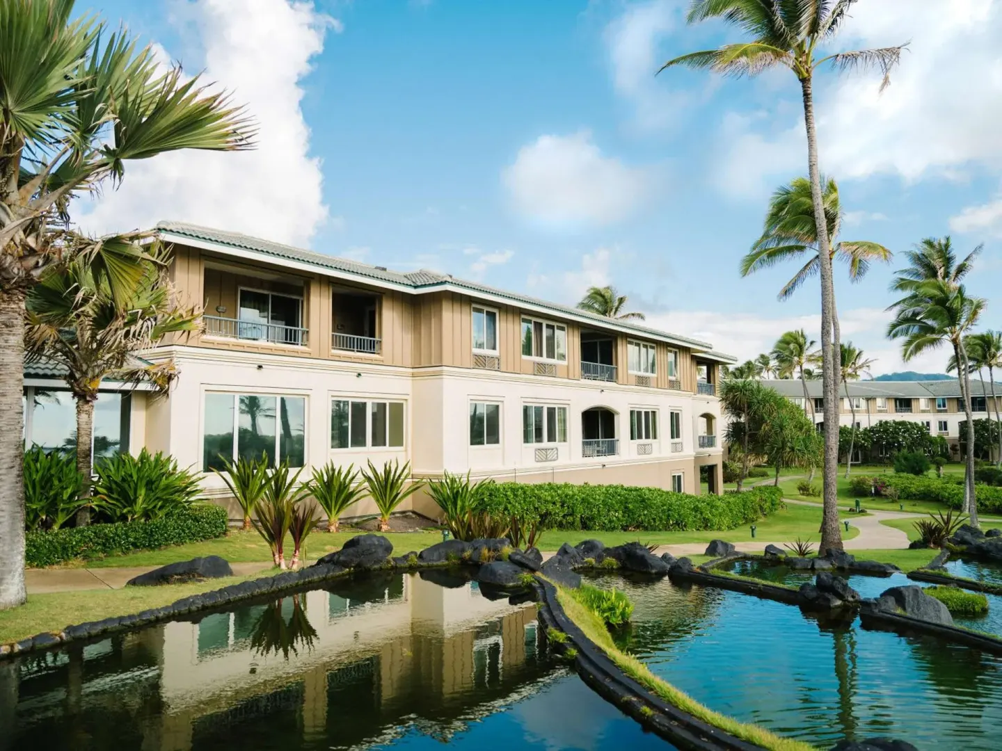 Lagoon gardens and resort building at Hilton Vacation Club The Point At Poipu Kauai.