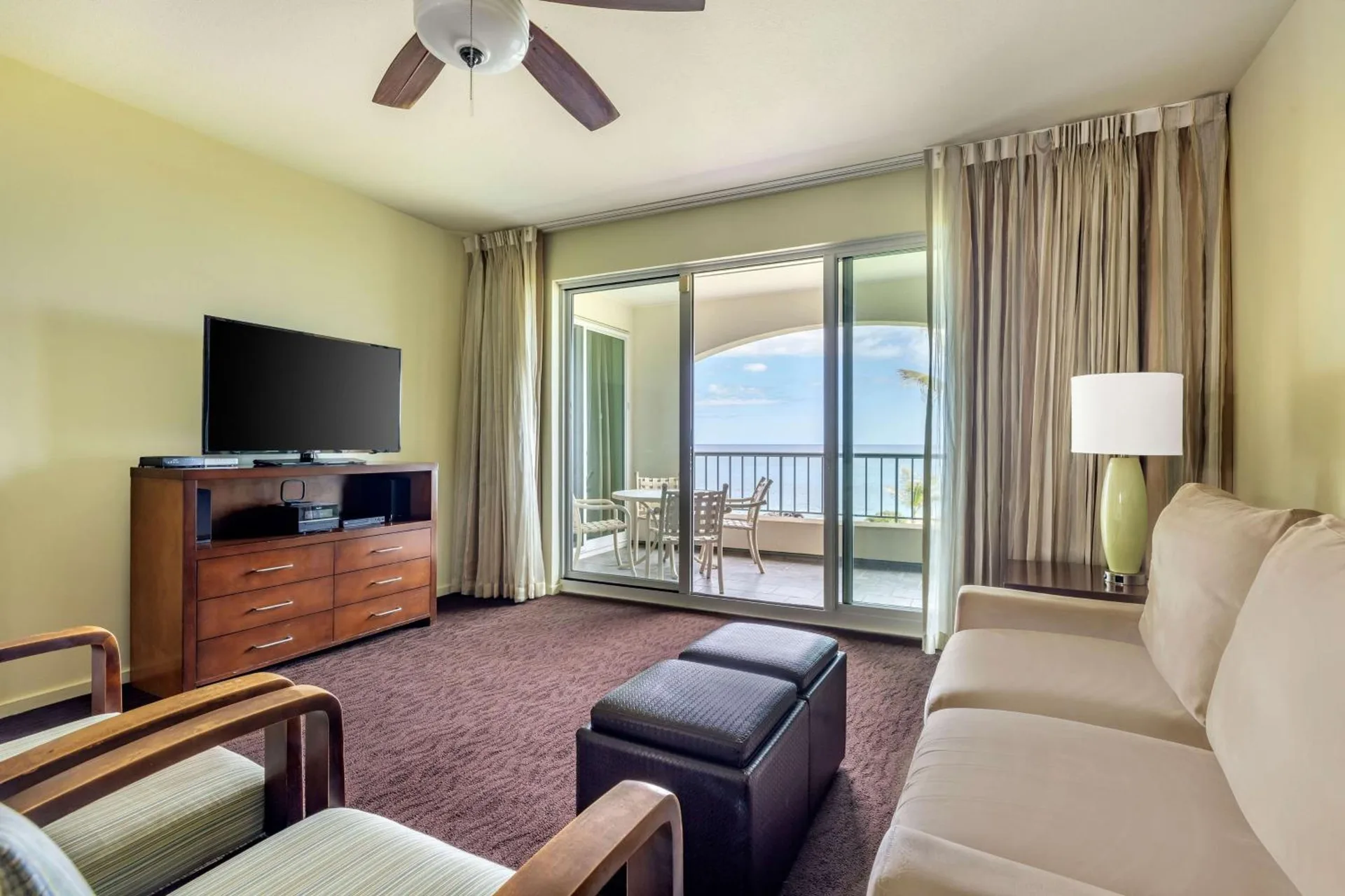 Living room with balcony and ocean view at Hilton Vacation Club The Point At Poipu Kauai.