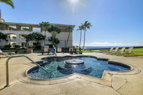 Outdoor spa pool with ocean and lounge chairs at Hilton Vacation Club The Point At Poipu Kauai.