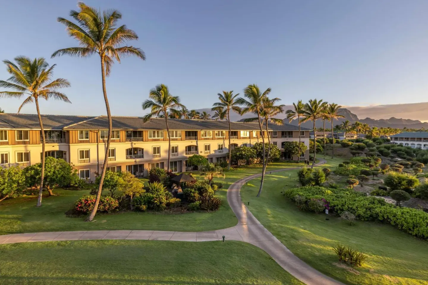 Palm-lined resort grounds and guest buildings at Hilton Vacation Club The Point At Poipu Kauai.