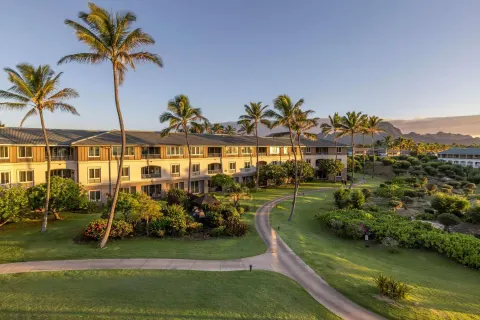 Palm-lined resort grounds and guest buildings at Hilton Vacation Club The Point At Poipu Kauai.