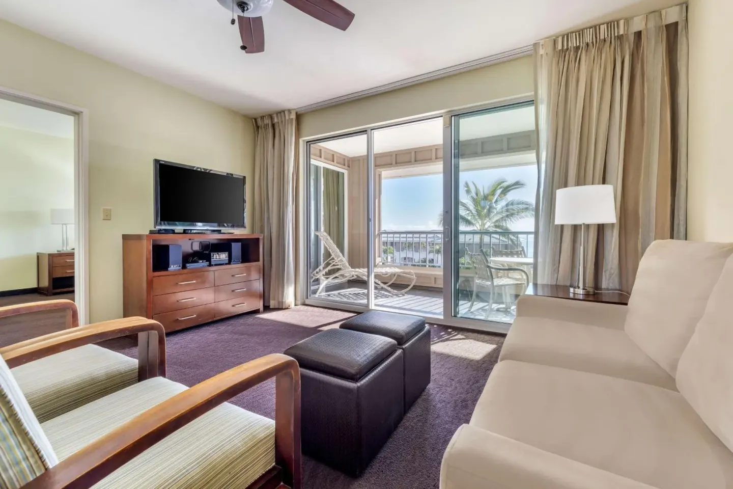 Living room with balcony at Hilton Vacation Club The Point At Poipu Kauai.