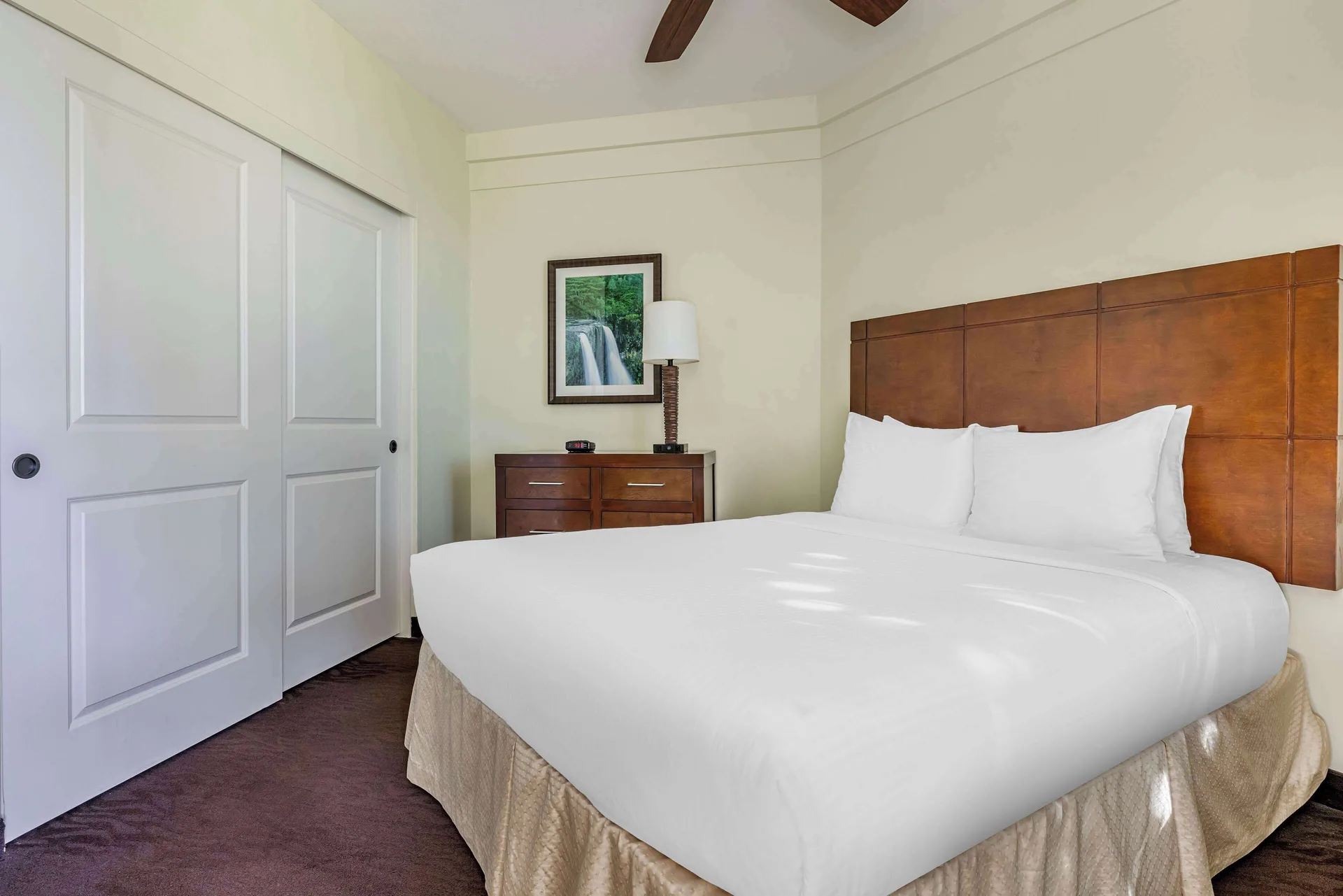 King bedroom with white bedding at Hilton Vacation Club The Point At Poipu Kauai.