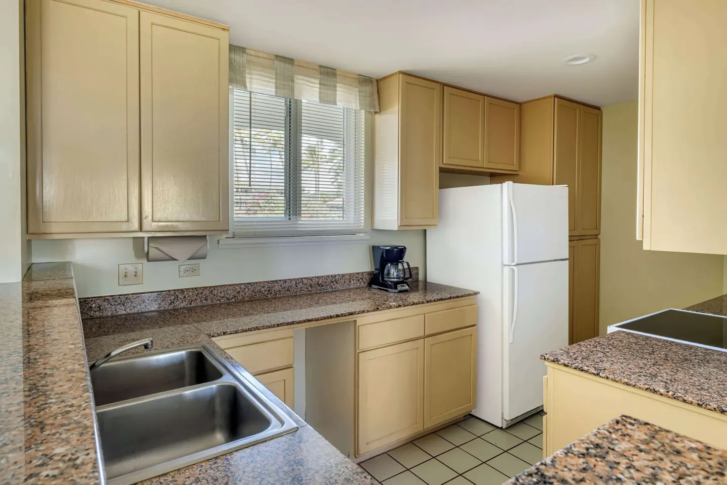 Kitchen counters and refrigerator at Hilton Vacation Club The Point At Poipu Kauai.