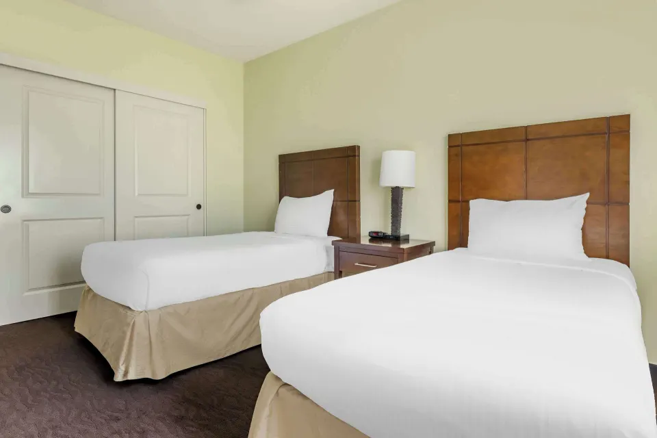 Two twin beds with wood headboards at Hilton Vacation Club The Point At Poipu Kauai.