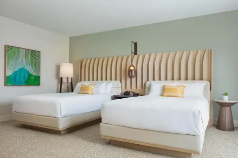 Two-bed guest room with botanical artwork at Hilton Waikoloa Village.
