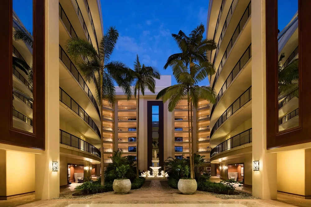 Hotel courtyard with palms, balconies and fountain at Hilton Waikoloa Village.