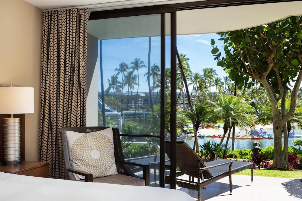 Guest room patio view of lagoon and palms at Hilton Waikoloa Village.