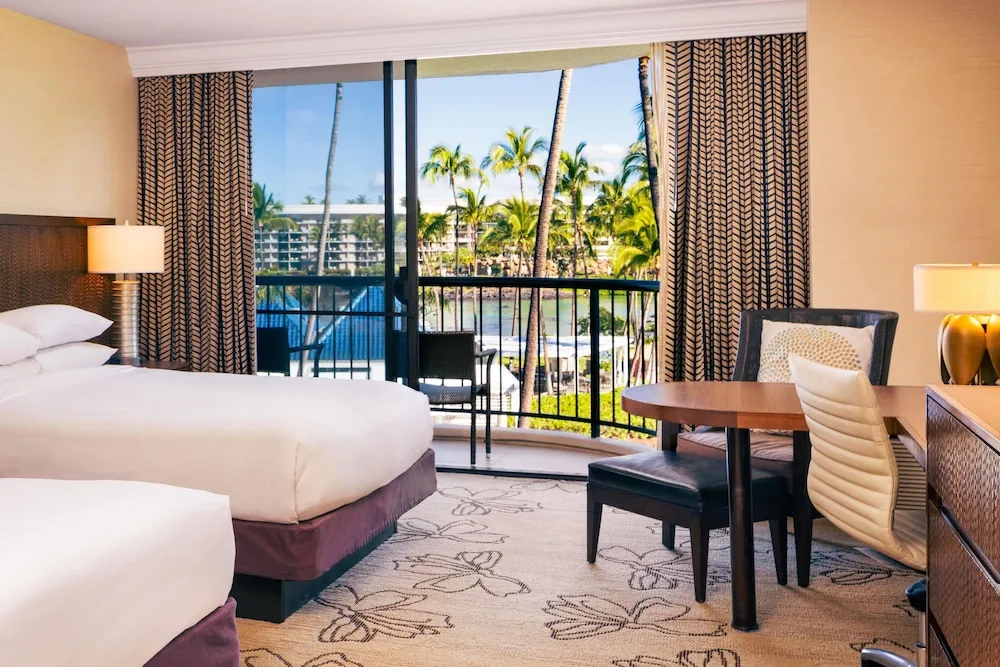 Two-bed guest room with lagoon-view balcony at Hilton Waikoloa Village.