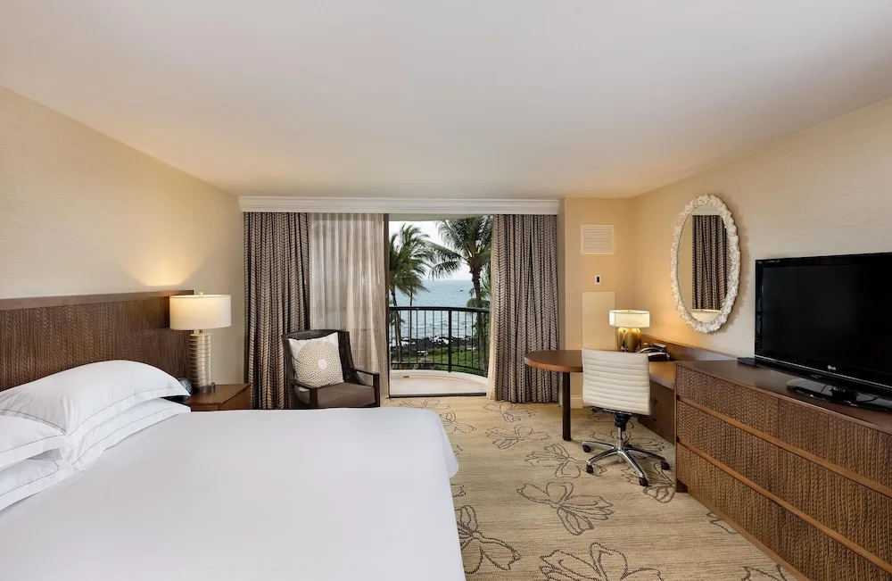 King guest room with ocean-view balcony at Hilton Waikoloa Village.