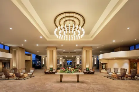 Open-air lobby seating and chandelier at Hilton Waikoloa Village.