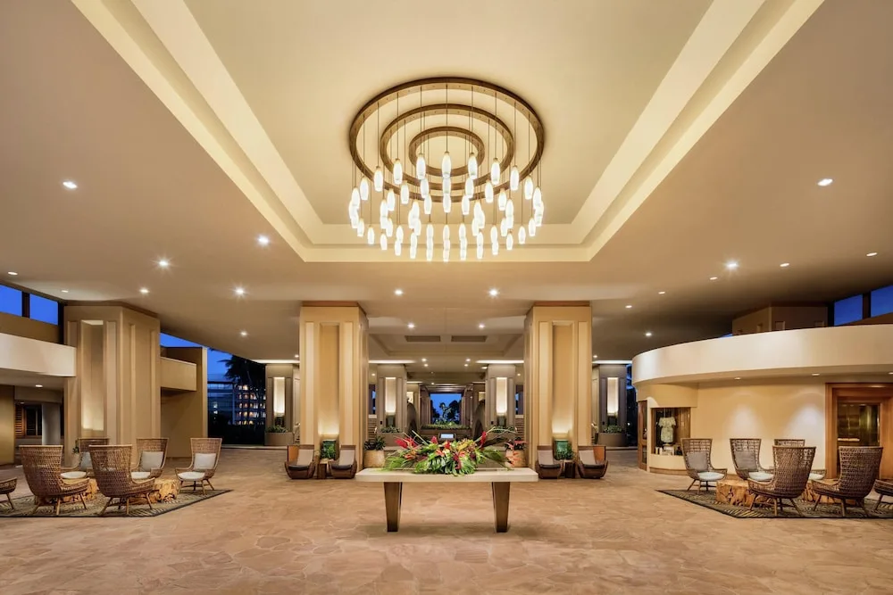 Open-air lobby seating and chandelier at Hilton Waikoloa Village.