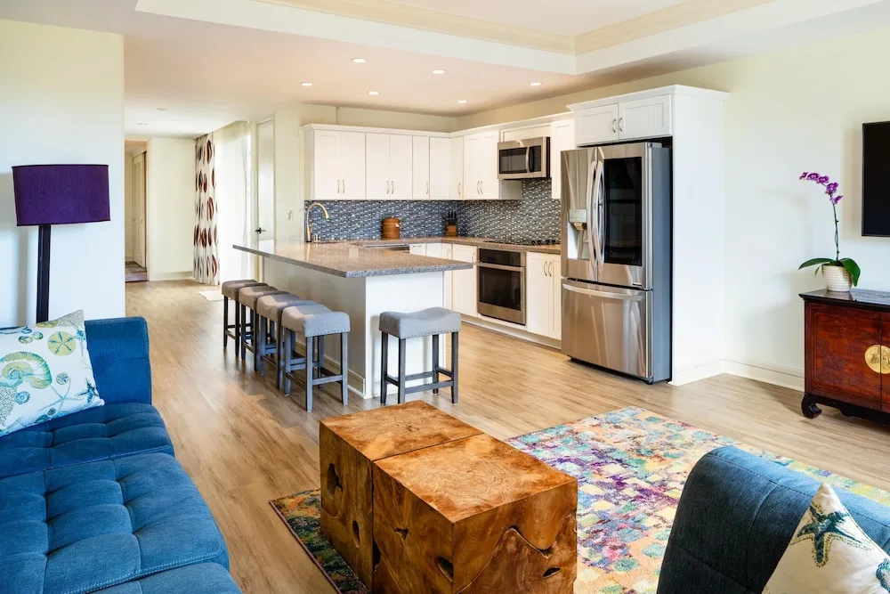 Suite living area with kitchen island and sofa at Hilton Waikoloa Village.