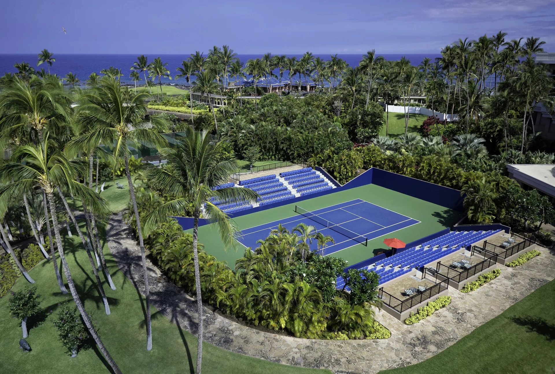 Tennis court surrounded by palms at Hilton Waikoloa Village.