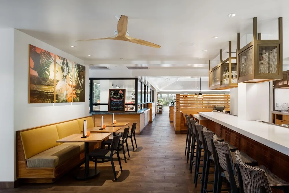 Bar and casual seating area with wood accents at Hilton Waikoloa Village.