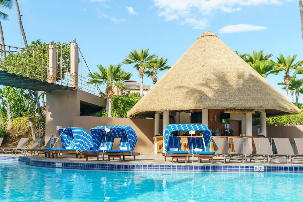 Kona Pool Bar hut, cabanas, and pool edge at Hilton Waikoloa Village.
