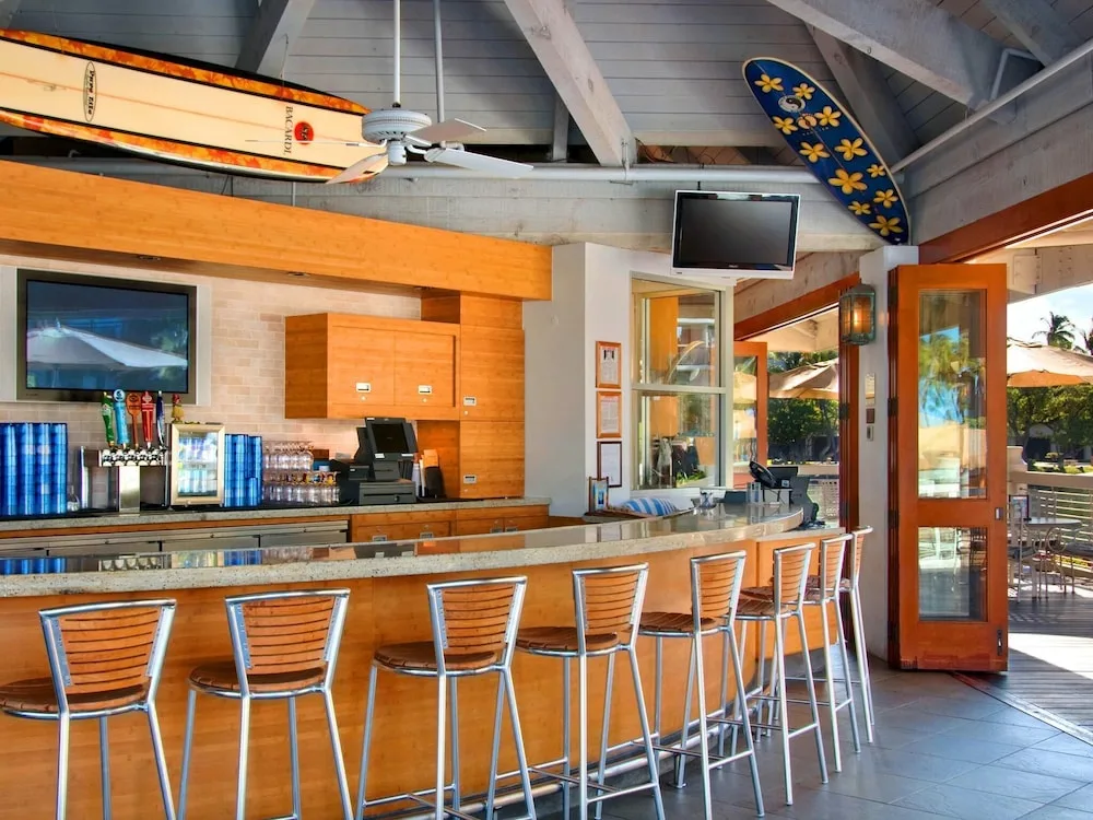 Open-air bar with counter seating at Hilton Waikoloa Village.