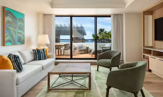 Adapted resort view room sitting area with balcony at Hilton Waikoloa Village.
