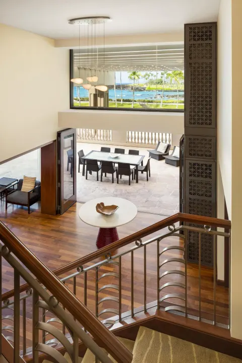 Upper-level view of suite terrace and ocean beyond at Hilton Waikoloa Village.