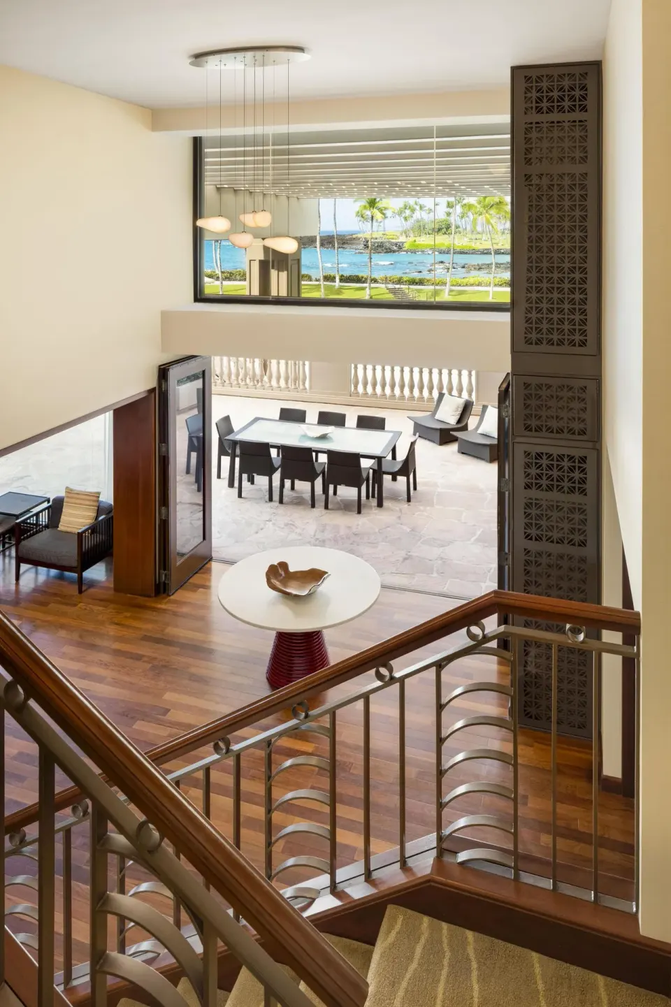 Upper-level view of suite terrace and ocean beyond at Hilton Waikoloa Village.