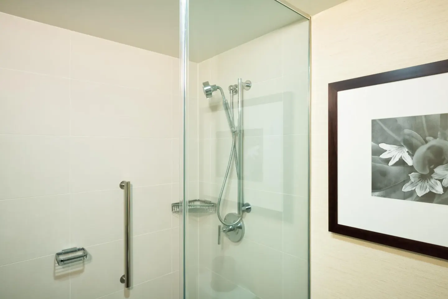 Makai Owner Suite glass shower with wall-mounted hand shower at Hilton Waikoloa Village.