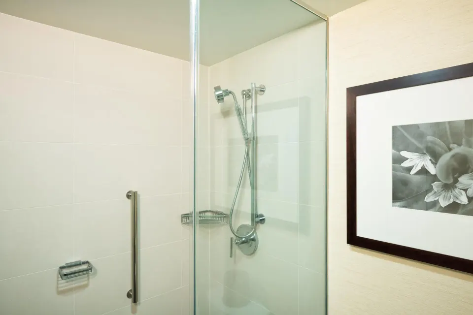 Makai Owner Suite glass shower with wall-mounted hand shower at Hilton Waikoloa Village.