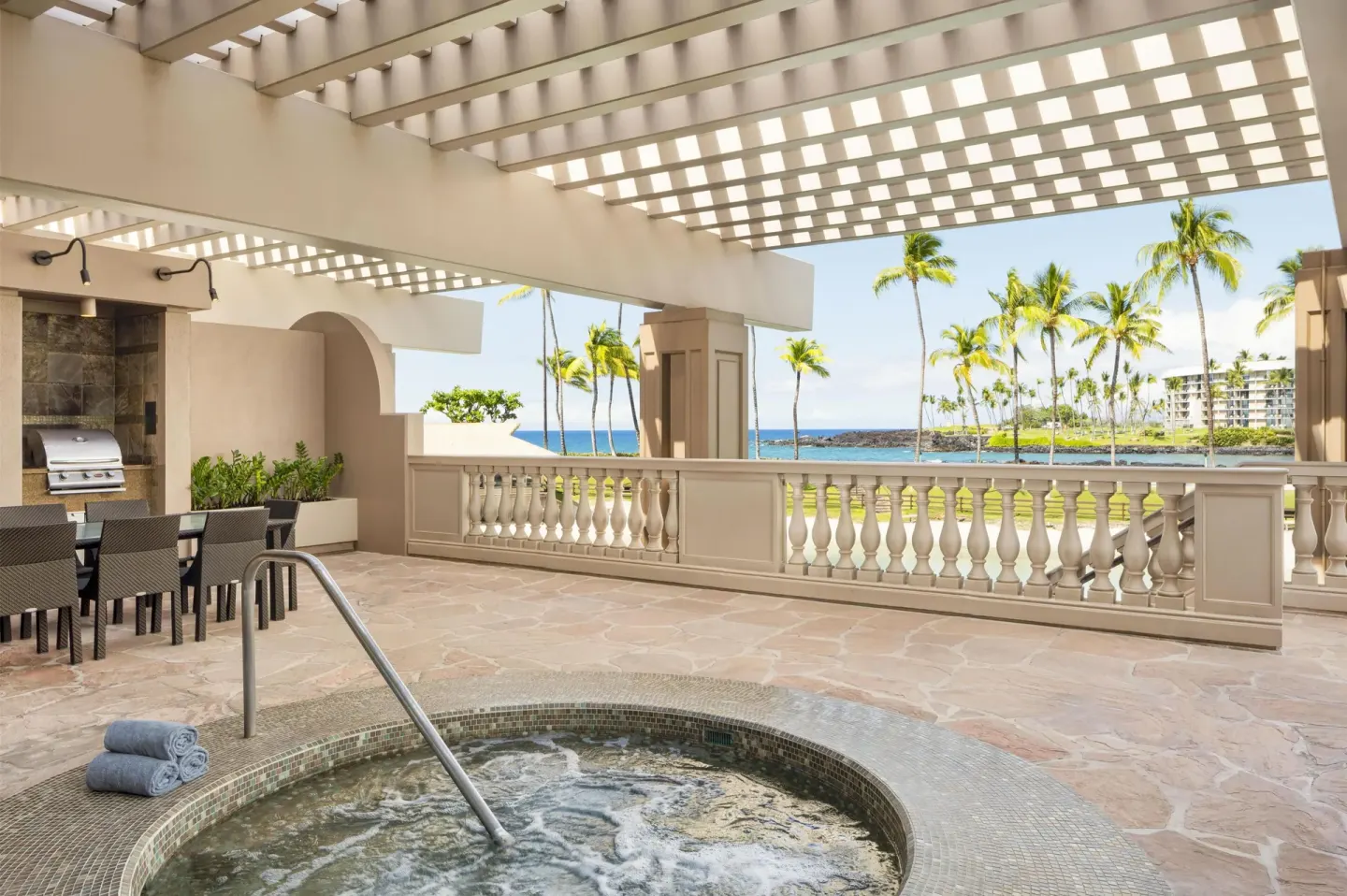 Makai Owner Suite terrace with spa tub and ocean view at Hilton Waikoloa Village.