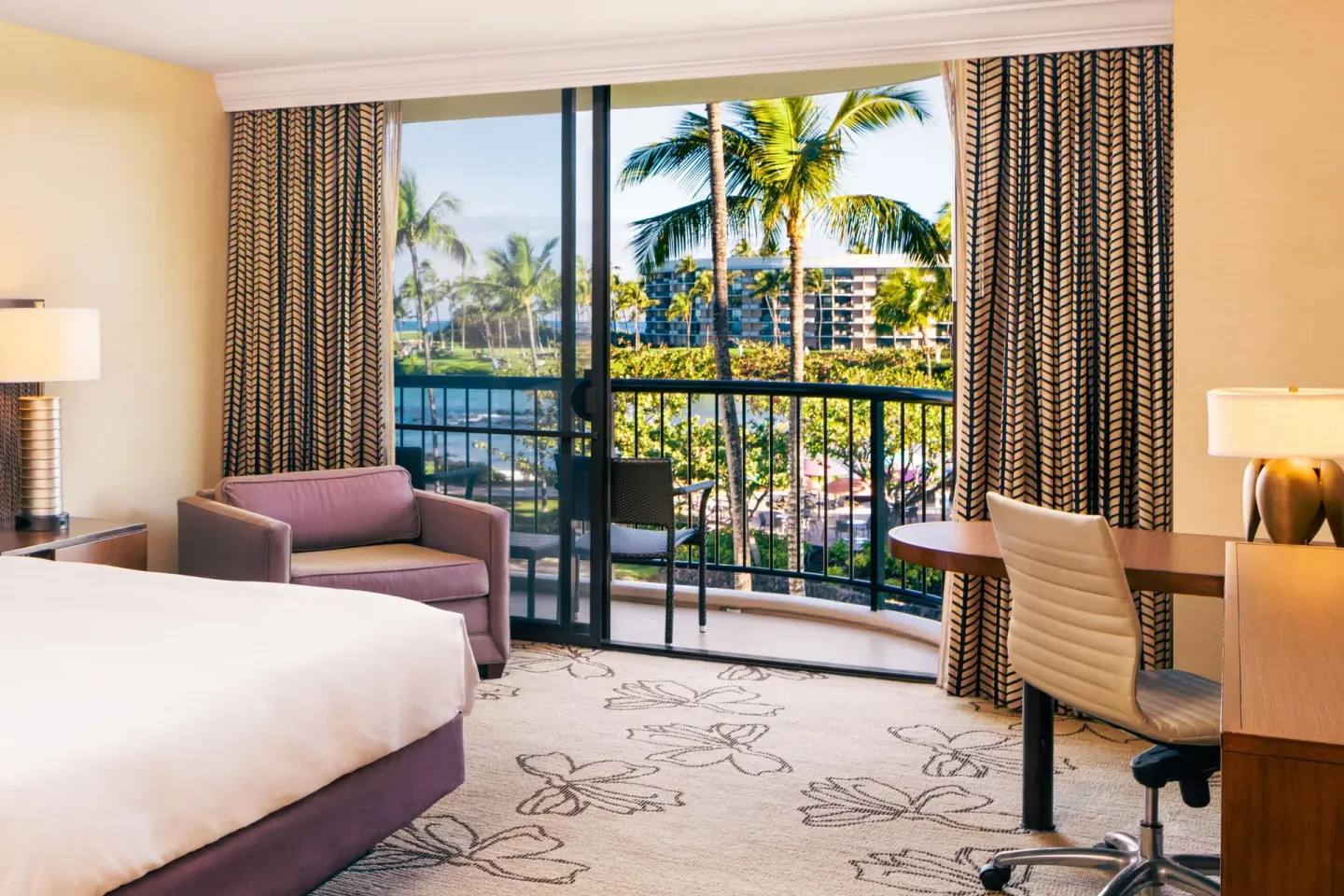 Makai Ocean View room with balcony, desk and palm views at Hilton Waikoloa Village.