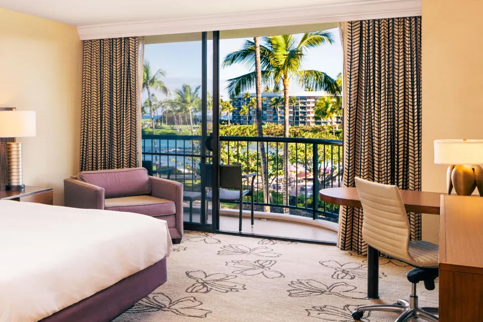 Makai Ocean View room with balcony, desk and palm views at Hilton Waikoloa Village.