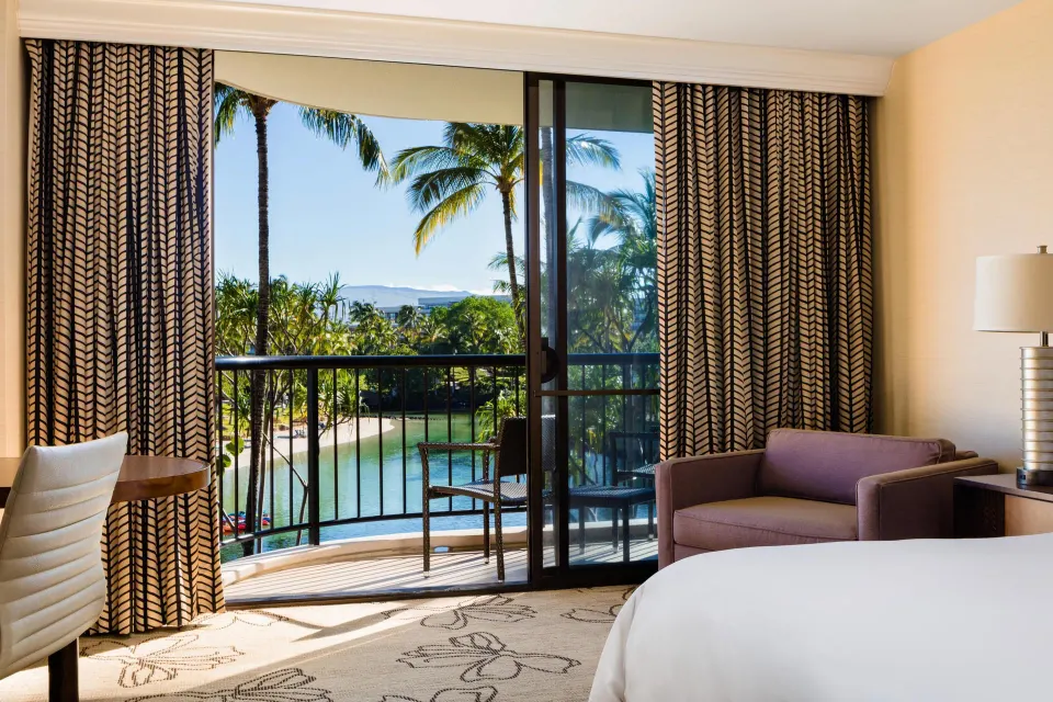 Makai Ocean View room balcony and seating by the lagoon at Hilton Waikoloa Village.