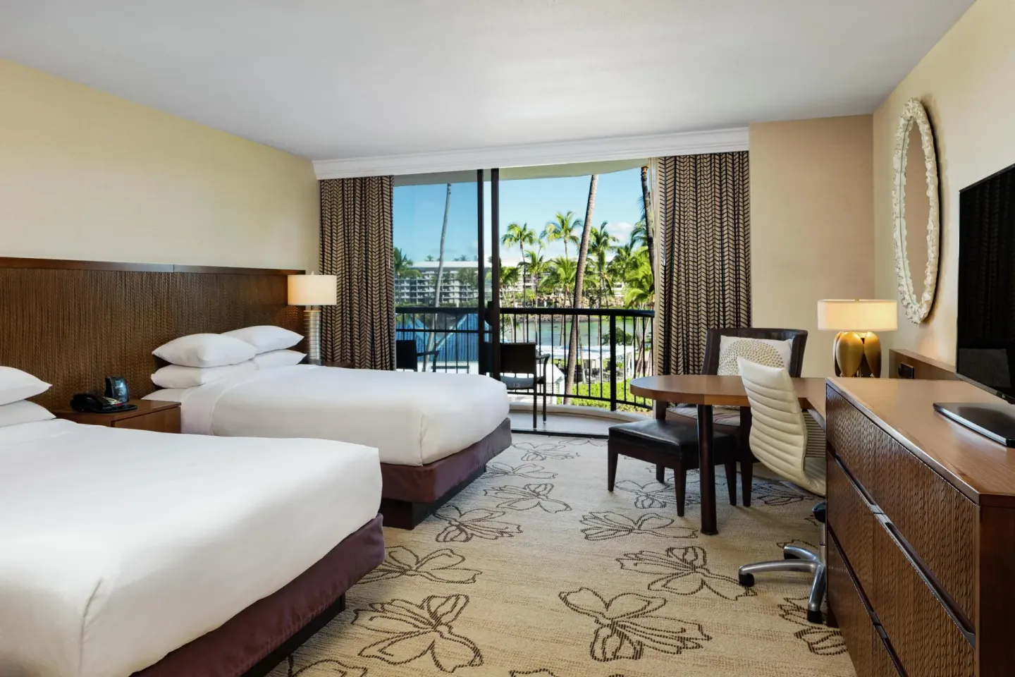 Makai Ocean View room with two beds, desk and balcony at Hilton Waikoloa Village.