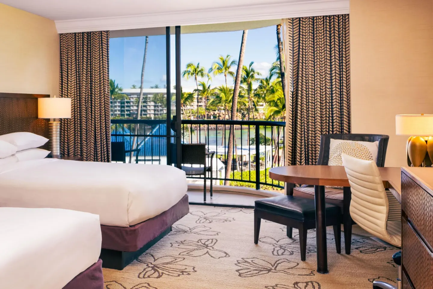 Makai Ocean View room with two beds and work table at Hilton Waikoloa Village.