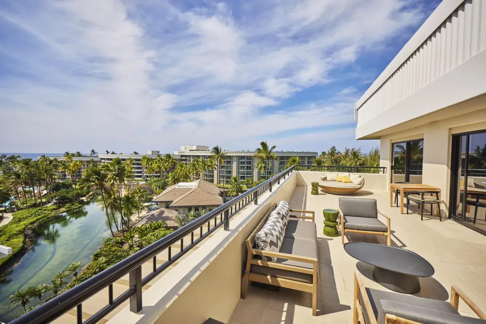 Palace One Bedroom Suite ocean-view balcony with lagoon at Hilton Waikoloa Village.