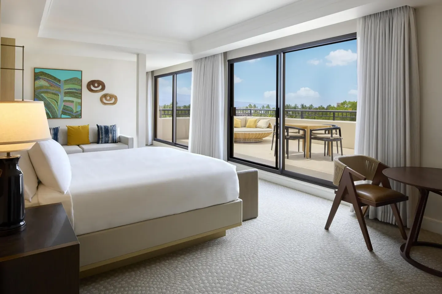 Palace Presidential Suite bedroom with balcony doors at Hilton Waikoloa Village.